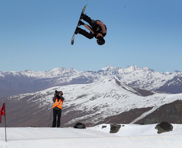 New Zealand snowboarder Carlos Garcia-Knight takes to the sky during his final run on his way to...