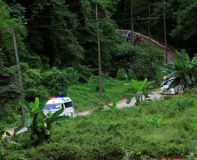 A group of ambulances travels from the Tham Luang Nang Non cave complex in northern Thailand. ...