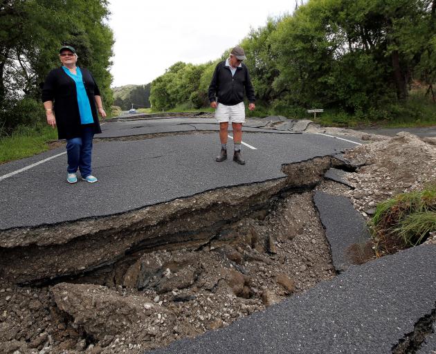 Chris and Viv Young at a damaged part of State Highway 1 near Blenheim. Photo: Reuters 