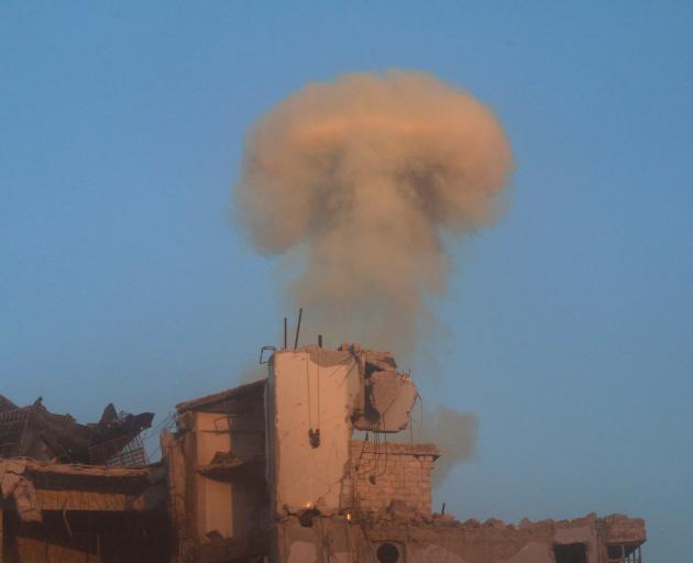 Smoke rises from a damaged building after a strike on the rebel-held besieged al-Shaar neighbourhood of Aleppo at the weekend. Photo: Reuters