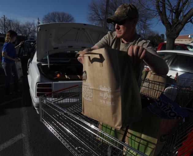 Residents shop for supplies after the evacuation order was lifted for communities downstream from the dam. Photo: Reuters 