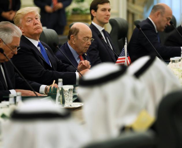 President Donald Trump (second left) and his delegation sit down to meet with Saudi Arabia's King...