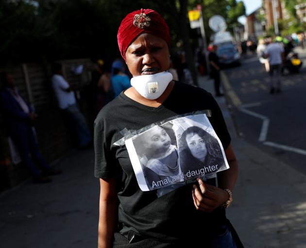 A woman with a poster of missing people. Photo: Reuters 