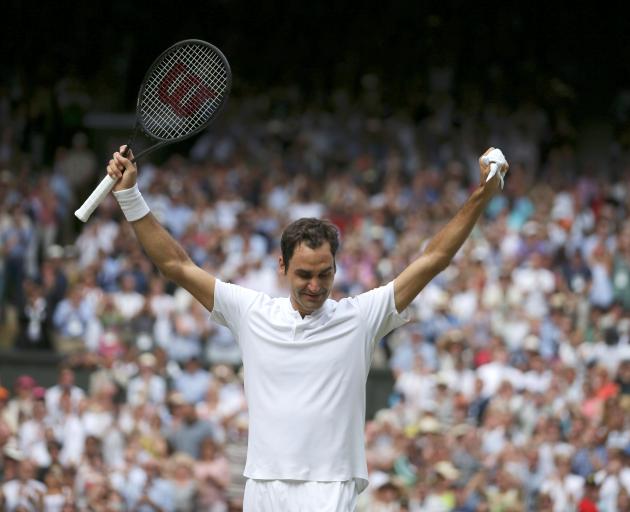 Roger Federer celebrates winning the final at Wimbledon. Photo: Reuters 