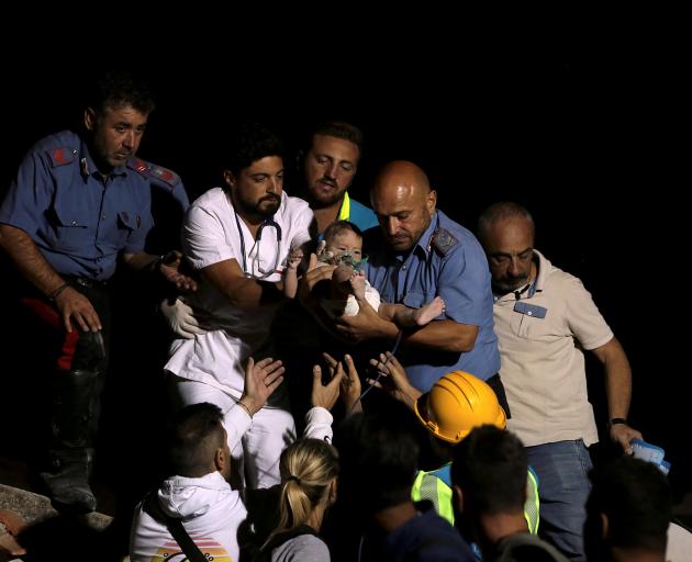 Rescuers found a baby boy called Pasquale in the wreckage and pulled him out alive seven hours...