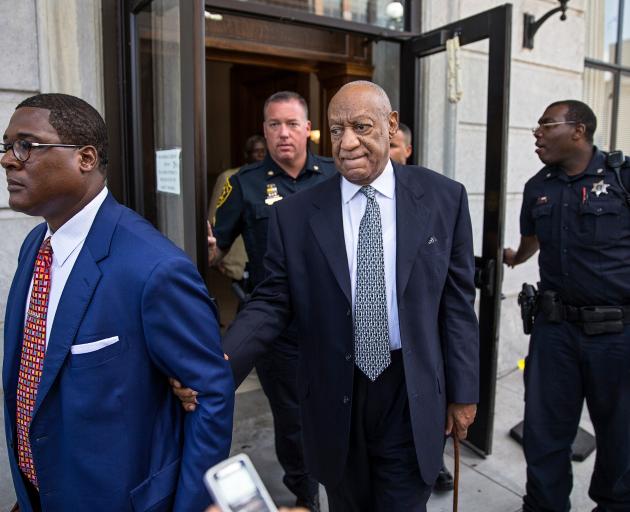 Bill Cosby (centre) leaves the courthouse with his new legal team. Photo: Reuters 