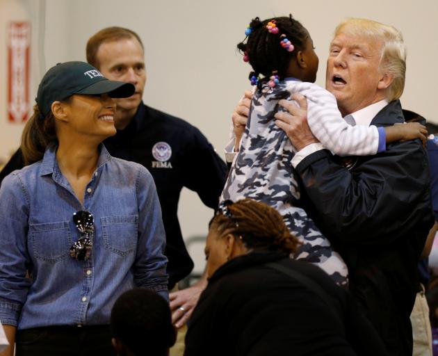 Donald Trump greets a little girl at a relief centre in Houston. Photo: Reuters