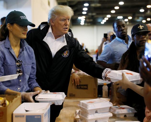 Donald and Melania Trump handed out meals at the relief centre. Photo: Reuters