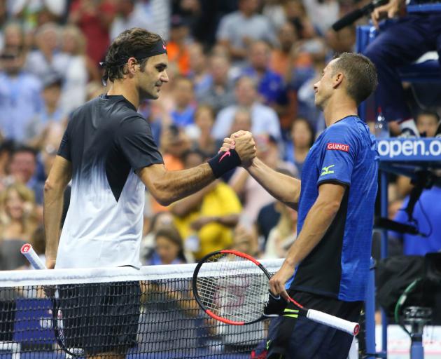 Roger Federer shakes hands with Philipp Kohlschreiber after the match. Photo: Jerry Lai-USA TODAY...