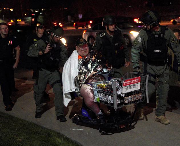 Shopper Patrick Carnes is evacuated in a cart by SWAT medics from the scene of the Walmart shooting. Photo: Reuters 