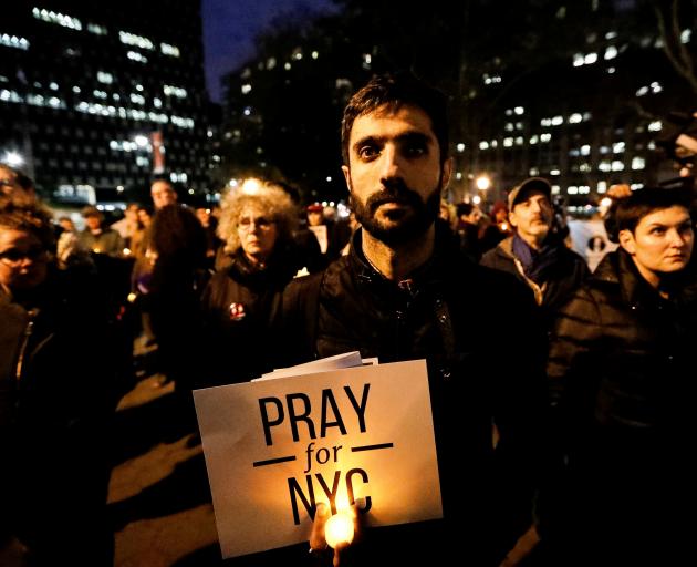 People gathered for a candlelight vigil for victims of the truck attack at Foley Square. Photo: Reuters 
