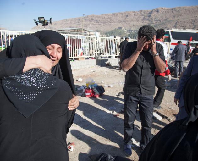 Women comfort each other in Sarpol-e Zahab county in Kermanshah. Photo: Reuters 