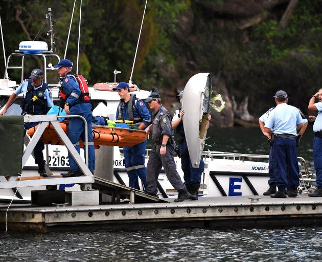 Emergency staff carry the body of a passenger recovered from the seaplane. Photo: Reuters 
