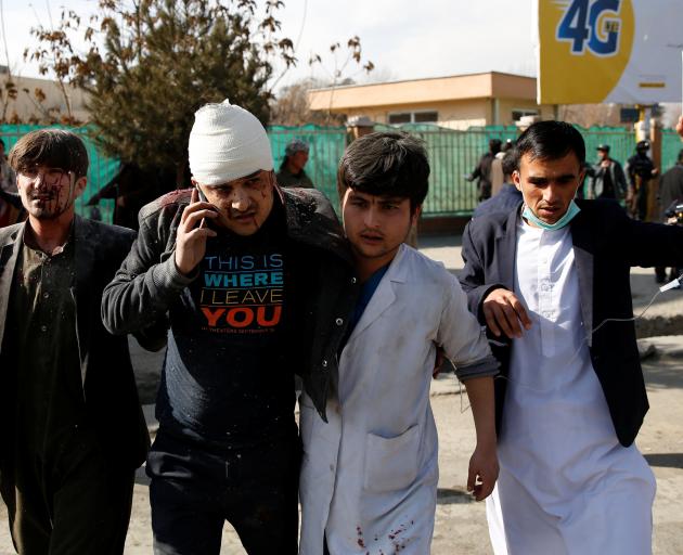 An injured man is helped from the site of the blast. Photo: Reuters 