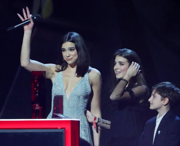 Dua Lipa accepts her award for British album. Photo: Reuters 