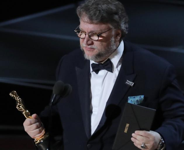 Guillermo del Toro accepting the best director award. Photo: Reuters 