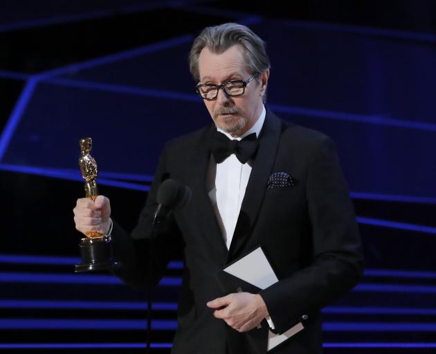 Gary Oldman accepts the Oscar for best actor. Photo: Reuters 