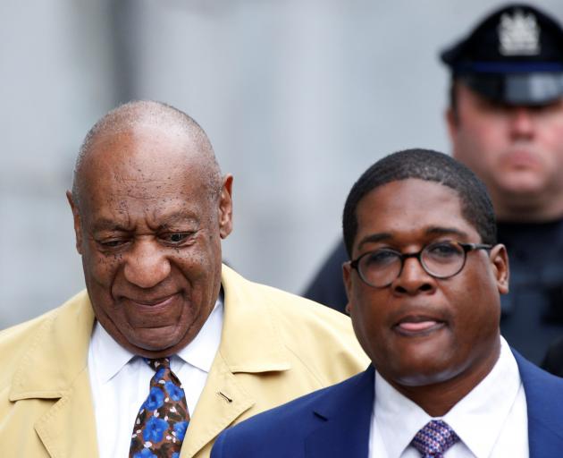 Bill Cosby (left) leaves the Montgomery County Courthouse in Norristown, Pennsylvania, after...