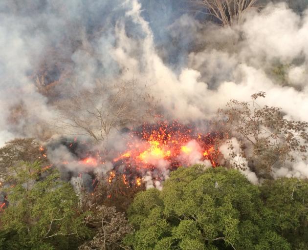 Lava spatters an area between fissures 16 and 20 on Big Island yesterday. Photo: USGS via Reuters 