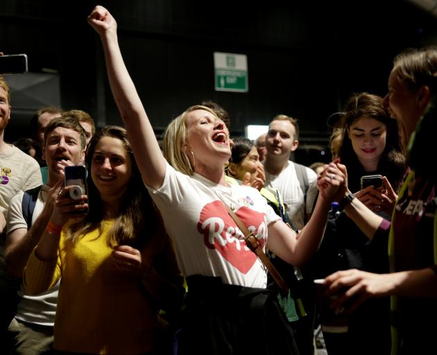 A pro-choice campaigner celebrates the decision to liberalise abortion laws in Dublin. Photo:...