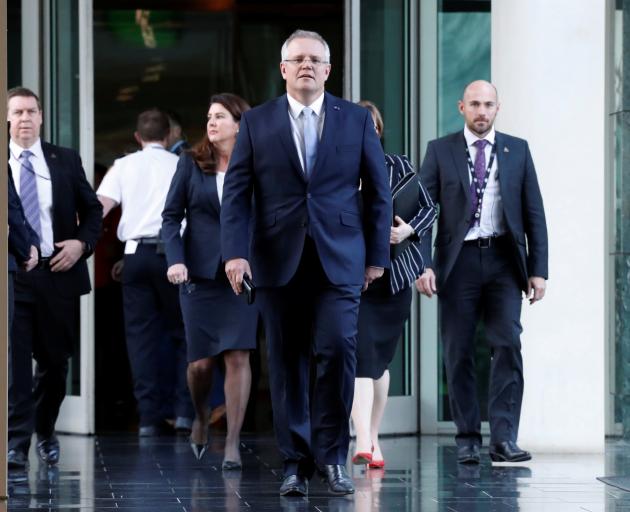 Treasurer of Australia Scott Morrison arrives for a party meeting in Canberra after which he...
