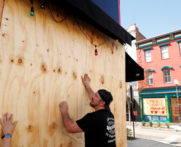 Workers board up a window in Wilmington, North Carolina. Photo: Reuters 