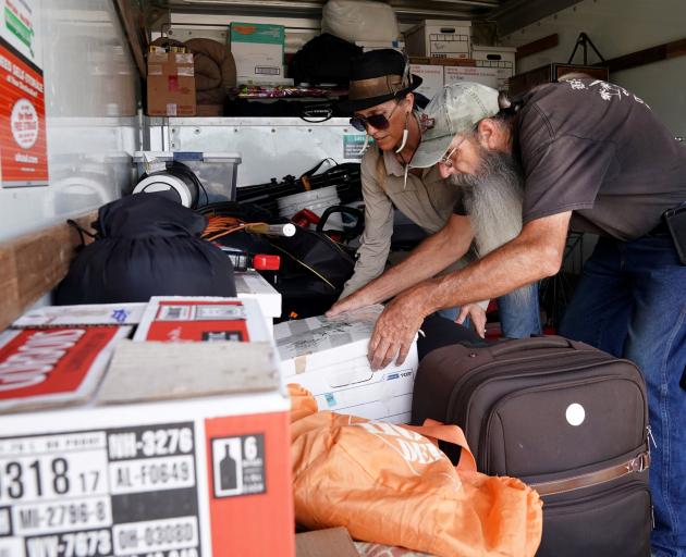 Blaire Johnson and Mike Driver load possessions into a rental truck before Hurricane Florence...