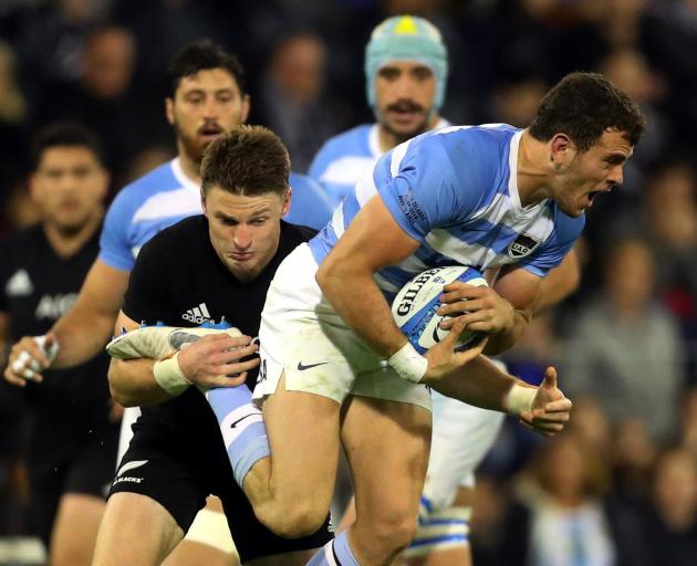 Emiliano Boffelli tries to break out of a Beauden Barrett tackle. Photo: Reuters 