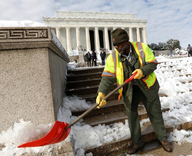 Furloughed National Park Service employee clear the steps of the Lincoln Memorial in Washington...