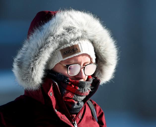 A student's glasses fog in subzero temperatures while walking to class at the University of...
