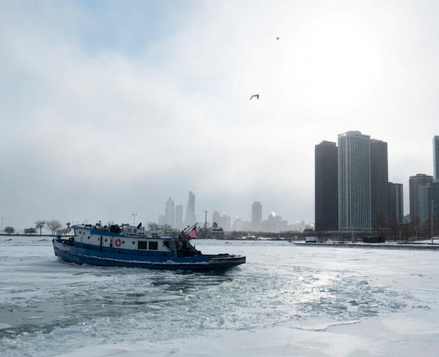 Icebreaker tugboat the James J. Versluis ploughs through a frozen Lake Michigan. Photo: Reuters 