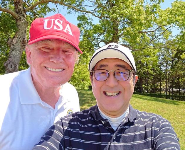 Japan's Prime Minister Shinzo Abe poses for a selfie with U.S. President Donald Trump at Mobara...