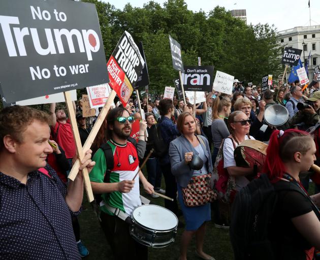 People protest outside Buckingham Palace on Monday during the state visit of Donald Trump. Photo:...