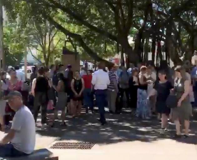 People gather outside during an evacuation near Darwin Entertainment Centre on Monday. Photo:...