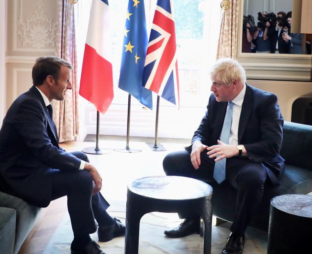 Emmanuel Macron (left) insists that Britain's destiny lies in Boris Johnson's hands alone. The EU...