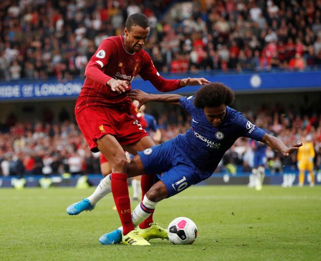 Liverpool's Joel Matip and Chelsea's Willian compete for the ball. Photo: Action Images via Reuters