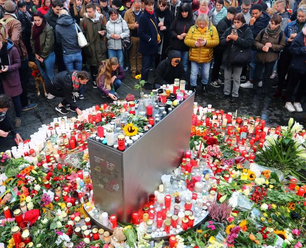 Mourners gather at the market square in Halle on Thursday. Photo: Reuters 