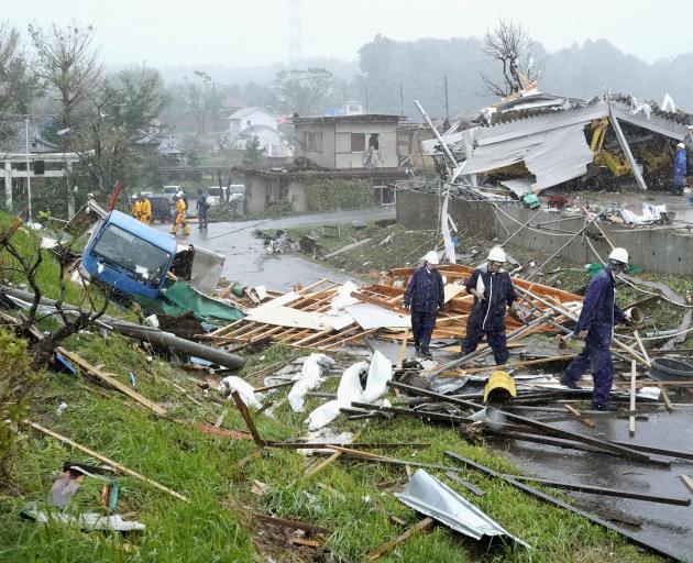Destroyed houses, cars and power poles in Ichihara, east of Tokyo on Saturday. Photo: Kyodo via...