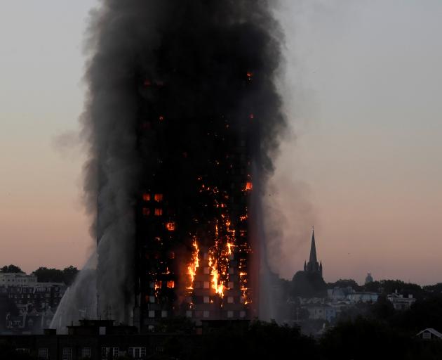 Flames and smoke billow from the West London building in 2017. Photo: Reuters