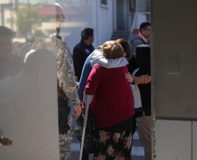 People who knew the victims console each other at an air force base in Santiago earlier this week...
