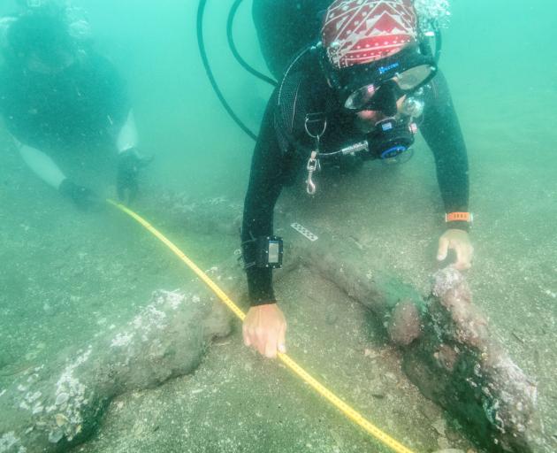 Archaeologists measure a 16th century anchor that may represent ground tackle used during the...