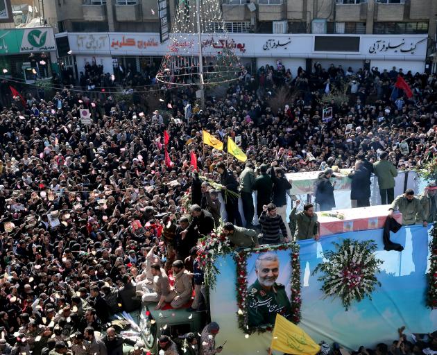 A huge crowd attend the funeral procession and burial for Iranian Major-General Qassem Soleimani,...