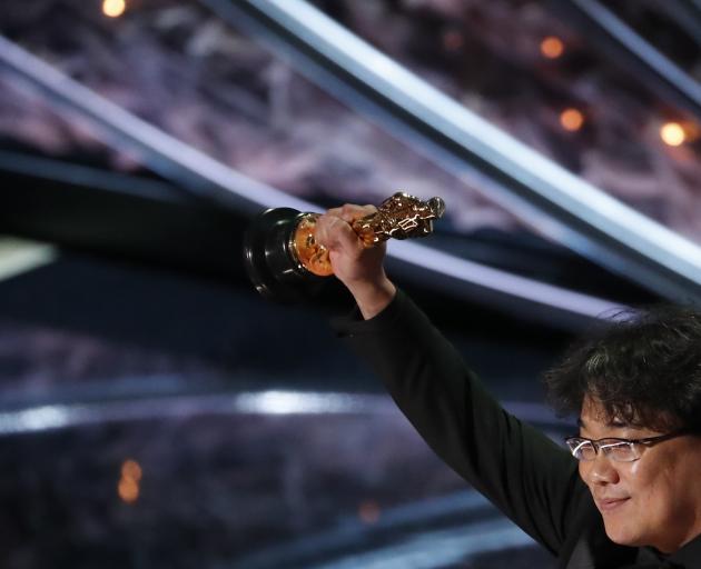 Parasite director Bong Joon-ho accepts the Oscar for best foreign language Film. Photo: Reuters 