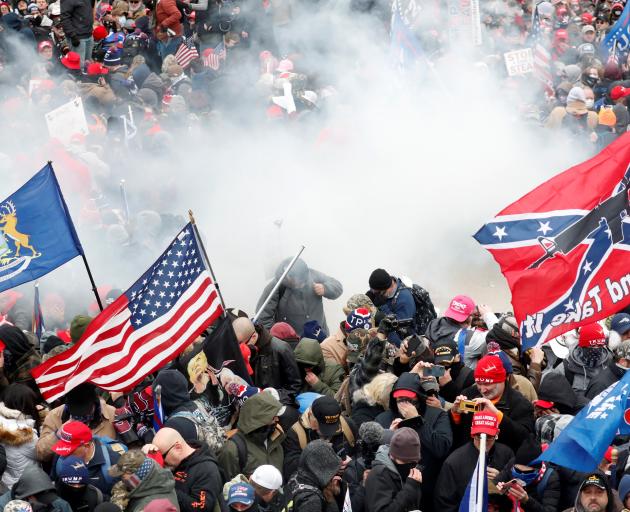 Tear gas is released into a crowd of protesters in Washington DC on Wednesday. Photo: Reuters