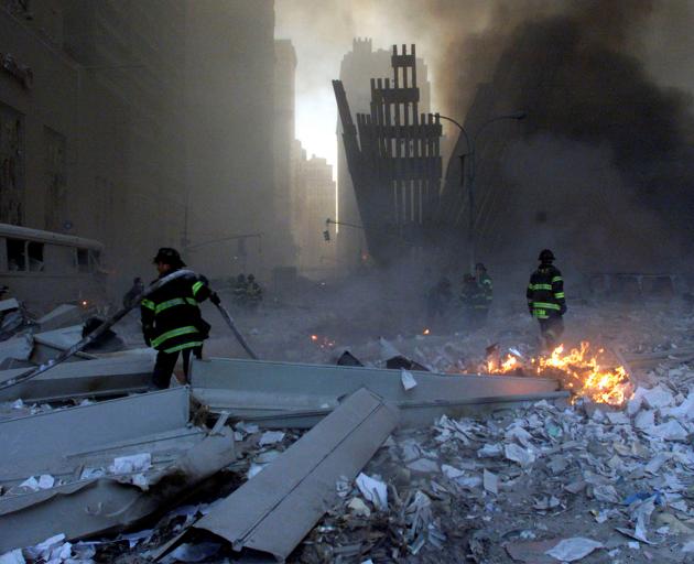 Firemen work around the World Trade Center after both towers collapsed. Photo: Reuters 