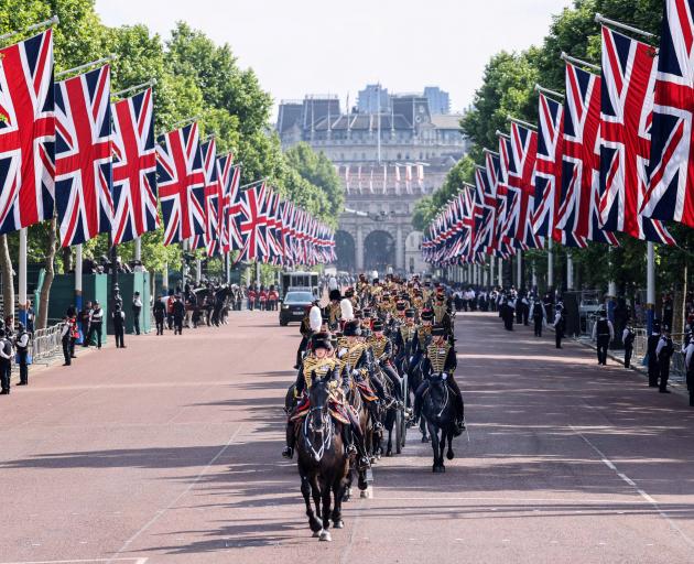 The King's Troop, Royal Horse Artillery, ride down The Mall on their way to fire ceremonial gun...