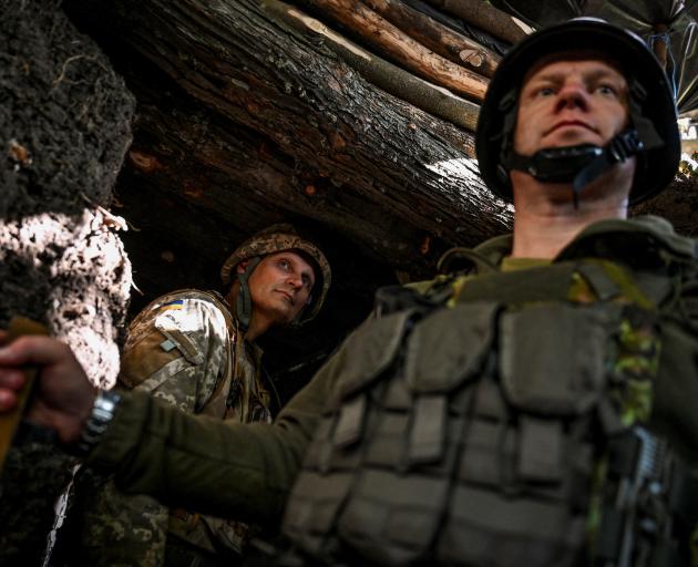 Ukrainian service members wait in a trench in the Zaporizhzhia region on Wednesday. Photo: Reuters 