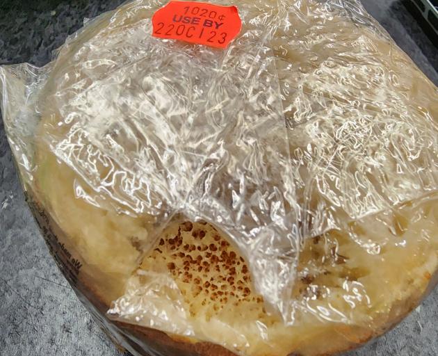 A packet of crumpets that has been nibbled on.