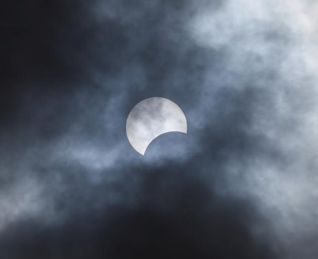 The moon begins to eclipse the sun at Niagara Falls in New York state. Photo: Reuters 