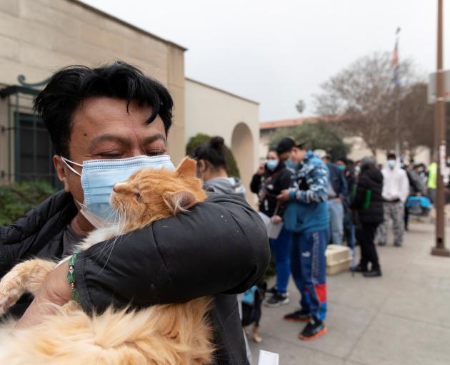 Edgar Hernandez waits outside the Pasadena Humane Society to surrender his cat, after evacuating...